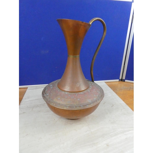 649 - A large copper jug.