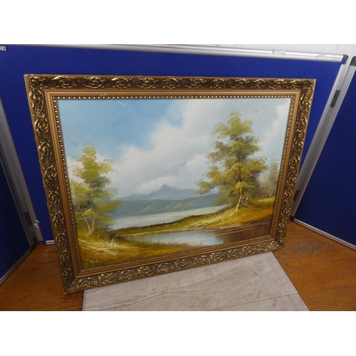 1028 - A painting of a mountain scene in gilt frame, signed Jackson.