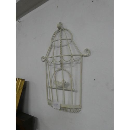 1038 - A decorative wall hanging of a bird in a cage.