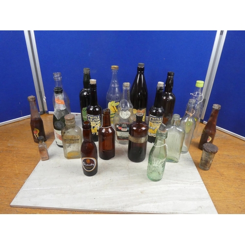 1098 - An assortment of vintage glass bottles.