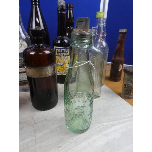 1098 - An assortment of vintage glass bottles.