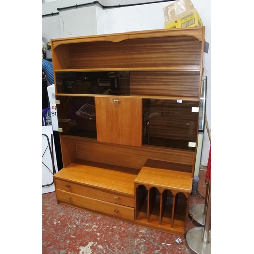 1120 - A large teak display and storage cabinet.