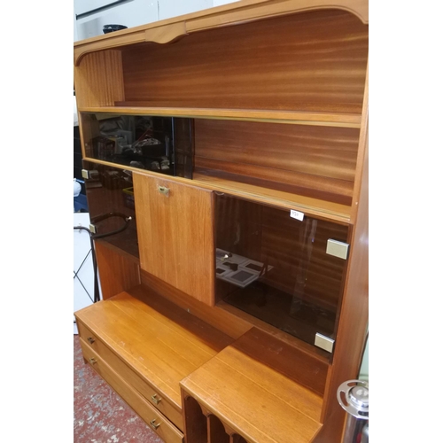 1120 - A large teak display and storage cabinet.