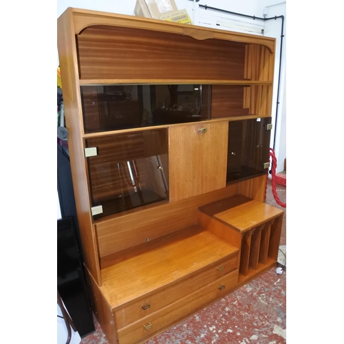 1120 - A large teak display and storage cabinet.