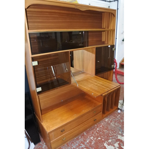 1120 - A large teak display and storage cabinet.