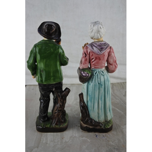 21 - A pair of vintage ceramic figures.