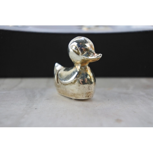 24 - A boxed set of six small brass place holder ducks.