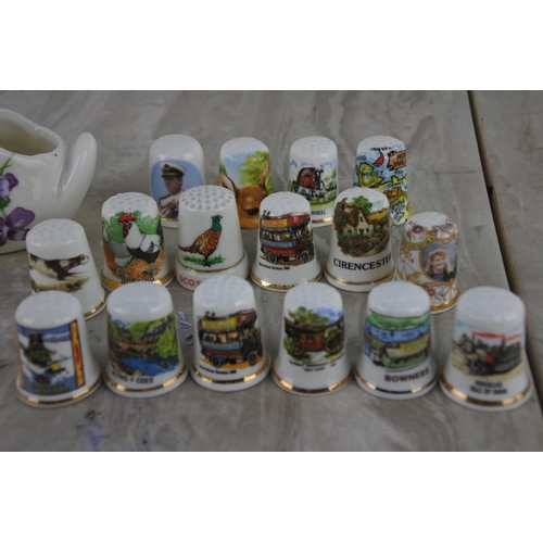 25 - A collection of ceramic thimbles and a pottery swan and boot ornament.