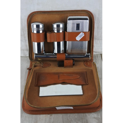 6 - A vintage leather cased gent's grooming set.