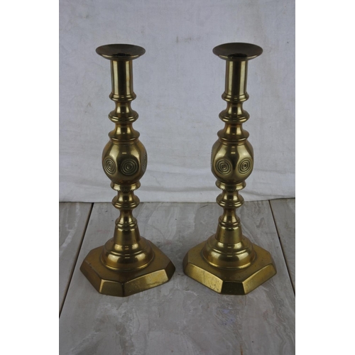 73 - A pair of brass candlesticks.  Approx 31cm.