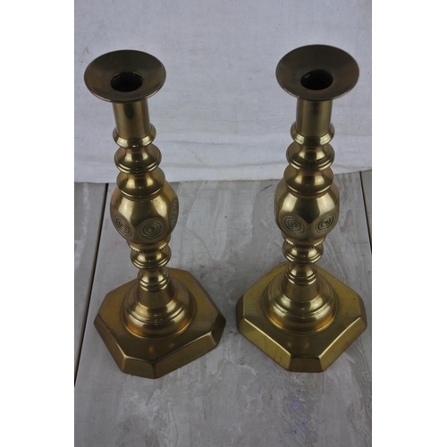 73 - A pair of brass candlesticks.  Approx 31cm.