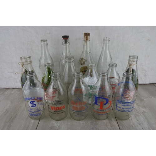 76 - A large lot of vintage glass milk bottles.