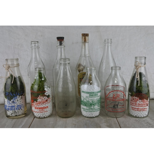 76 - A large lot of vintage glass milk bottles.