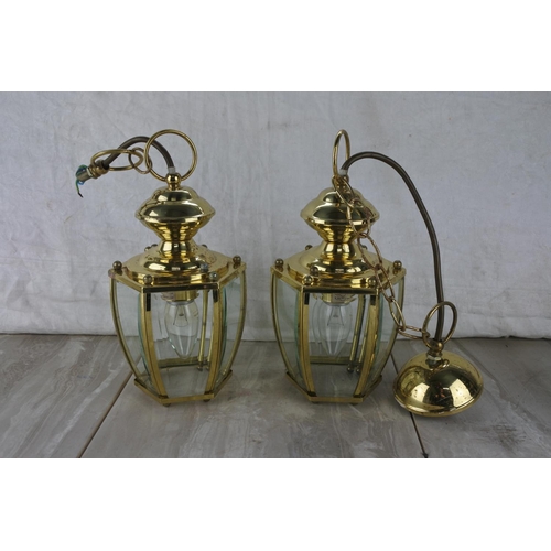 91 - A pair of lantern style centre lights and a pair of brass effect wall lights and shades.