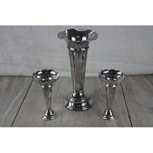 92 - A set of three silver plated bud vases.