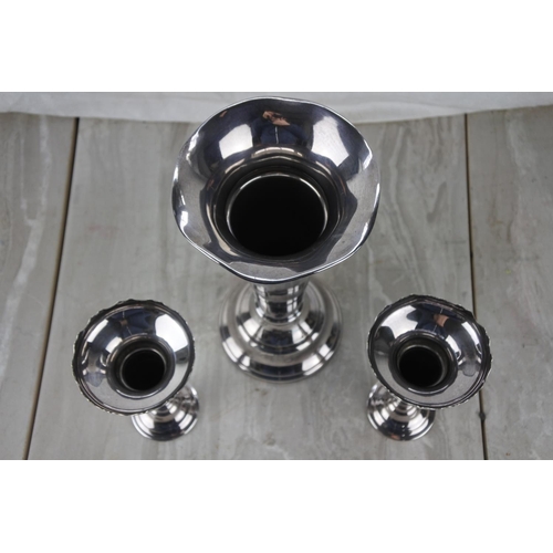 92 - A set of three silver plated bud vases.