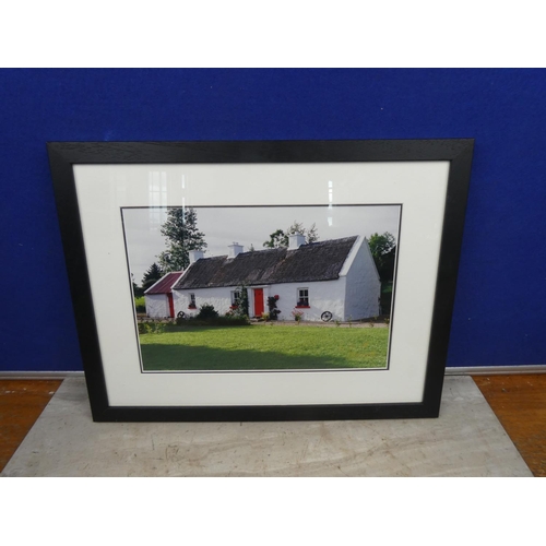 115 - A framed photograph by G & M Photography of a thatched cottage.  Approx 44x34cm.