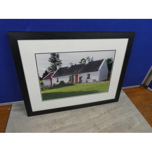 115 - A framed photograph by G & M Photography of a thatched cottage.  Approx 44x34cm.