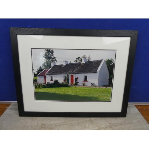 115 - A framed photograph by G & M Photography of a thatched cottage.  Approx 44x34cm.