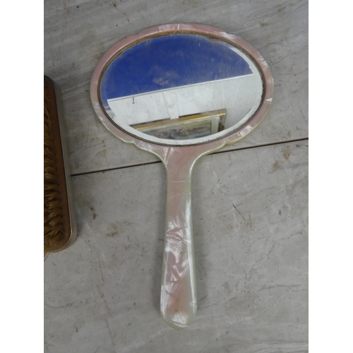 121 - A vintage dressing table mirror and two brushes.