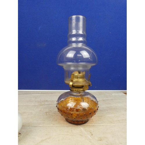 127 - An glass oil lamp and shade and a miniature ceramic based finger lamp and shade.  Approx 30cm.