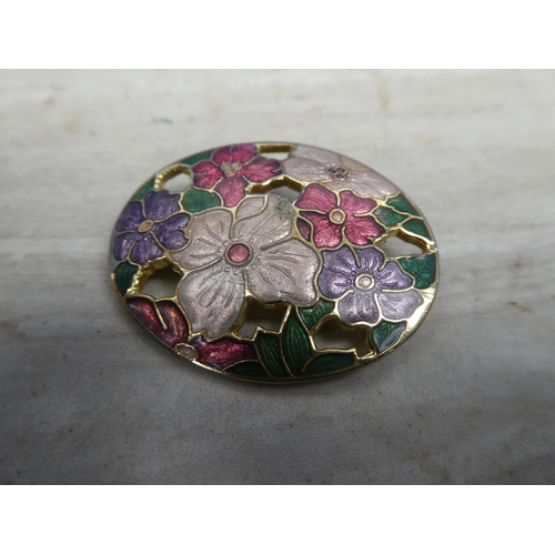 156 - Three floral patterned brooches.