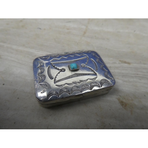 158 - An engraved white metal pill box with turquoise detail.