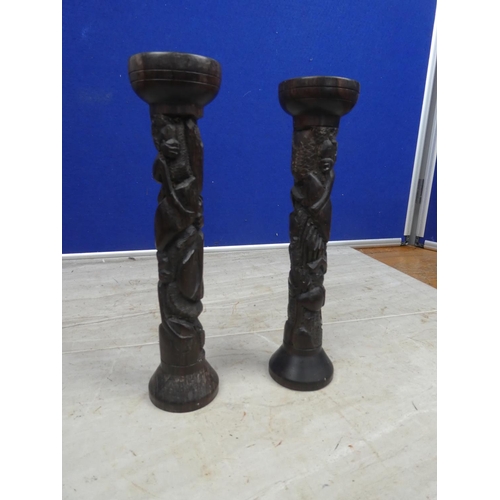 176 - A pair of carved wooden candlesticks.  Approx 23cm.