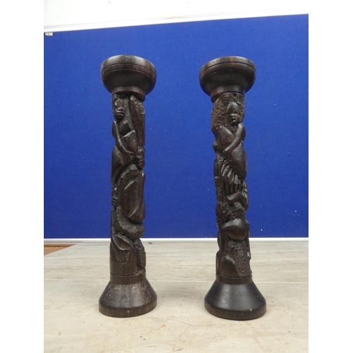 176 - A pair of carved wooden candlesticks.  Approx 23cm.