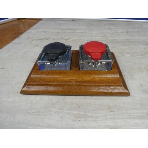 180 - A vintage wooden inkwell stand with two glass inkwells.