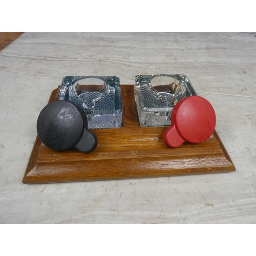 180 - A vintage wooden inkwell stand with two glass inkwells.