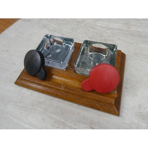 180 - A vintage wooden inkwell stand with two glass inkwells.