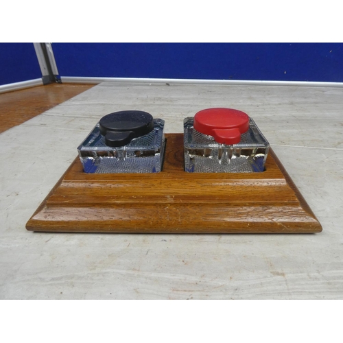 180 - A vintage wooden inkwell stand with two glass inkwells.