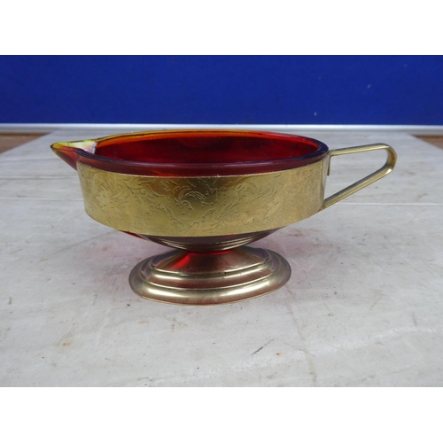 197 - A vintage ruby glass milk jug mounted in a gilt metal holder,