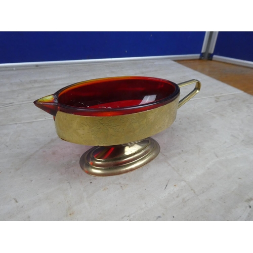 197 - A vintage ruby glass milk jug mounted in a gilt metal holder,