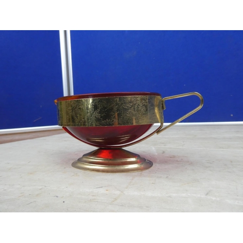 197 - A vintage ruby glass milk jug mounted in a gilt metal holder,