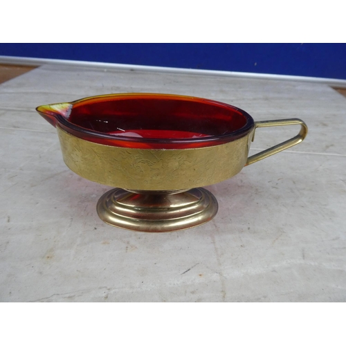 197 - A vintage ruby glass milk jug mounted in a gilt metal holder,