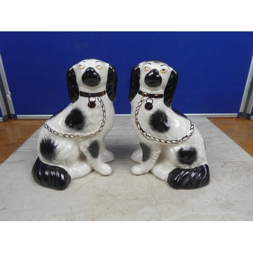 198 - A pair of vintage mantle dogs.  Approx 23cm.