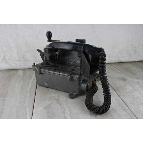 204 - A vintage military telephone.