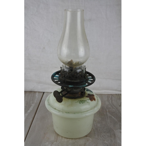 206 - An oil lamp with a hand painted font.  Approx 33cm.