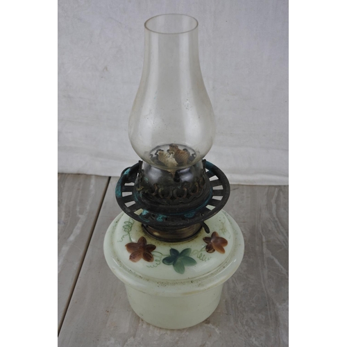 206 - An oil lamp with a hand painted font.  Approx 33cm.