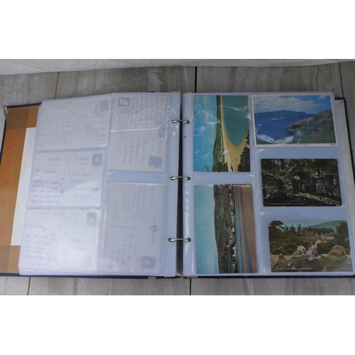 211 - A vintage postcard album and a lot of postcards.