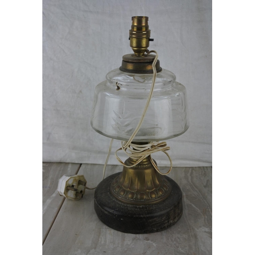 223 - An electric oil lamp table lamp base.  Approx 34cm.