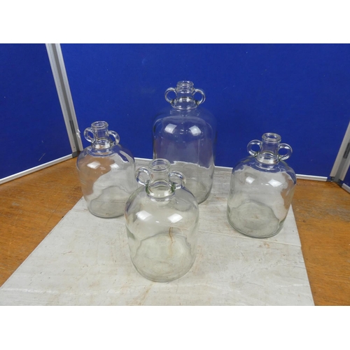 287 - Three small clear glass demijohn bottles and another.