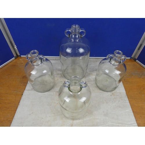 287 - Three small clear glass demijohn bottles and another.