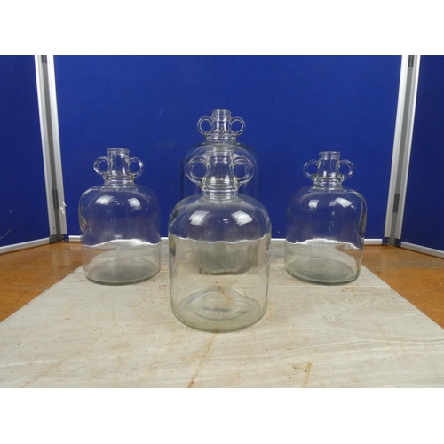 287 - Three small clear glass demijohn bottles and another.