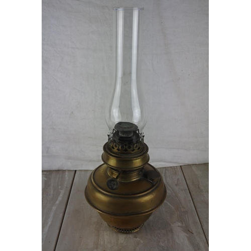 327 - An antique oil lamp with a brass font and glass funnel.  Approx 45cm.