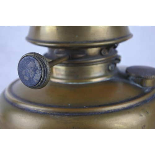 327 - An antique oil lamp with a brass font and glass funnel.  Approx 45cm.