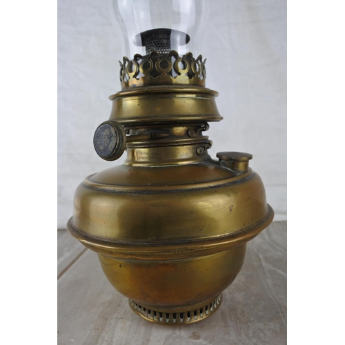 327 - An antique oil lamp with a brass font and glass funnel.  Approx 45cm.