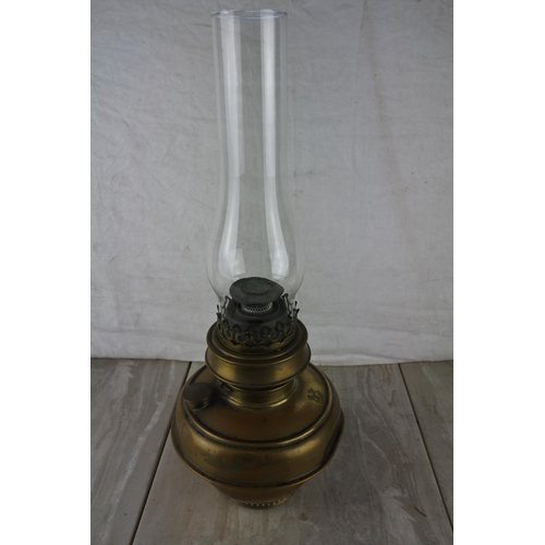 327 - An antique oil lamp with a brass font and glass funnel.  Approx 45cm.